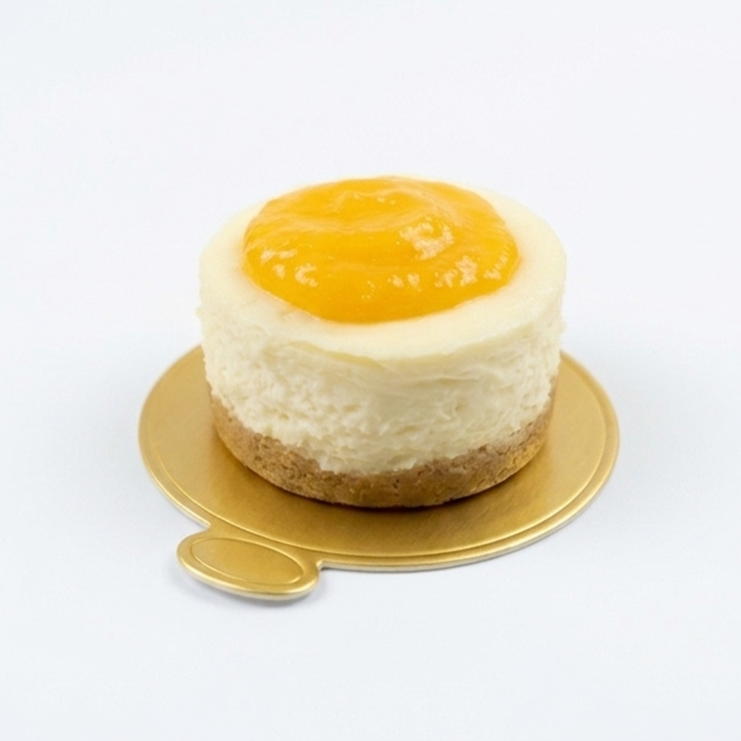 Mini Lemon Cheesecake with fruit topping on a golden cake board